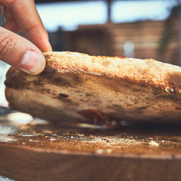 Pizza mit knusprigem Boden wird angehoben