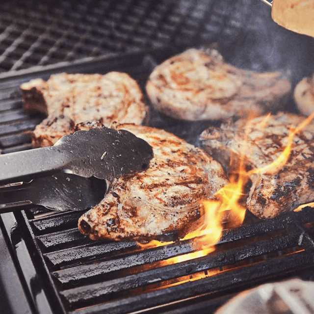 Gusseisen-Grillrost im Einsatz mit Hähnchenfleisch und sichtbarer Flamme auf dem Gasgrill
946761_946763_946765_946767